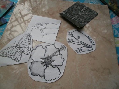 Use carbon paper to trace the images onto your coaster if your background is light enough or just one color.